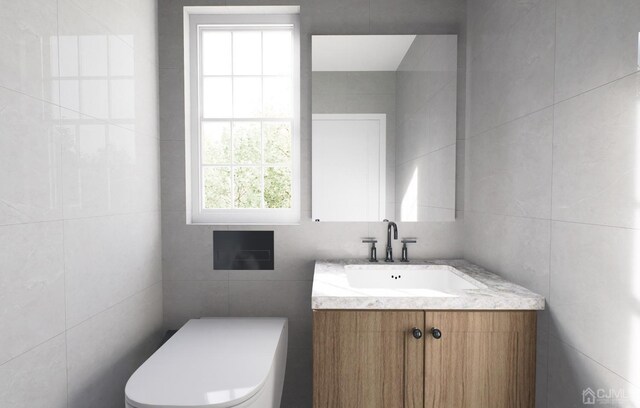 bathroom with vanity, tile walls, and toilet