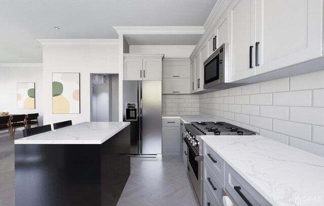 kitchen with tile patterned floors, tasteful backsplash, a center island, light stone counters, and appliances with stainless steel finishes