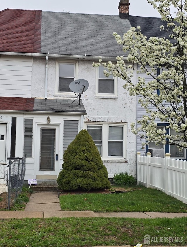 47 Lufberry Ave, New Brunswick, NJ 08901 - townhome / multi-family property with roof with shingles, a chimney, and stucco siding