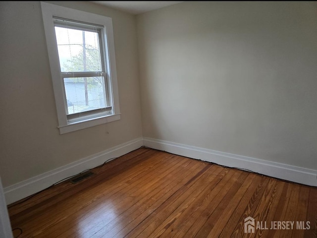 47 Lufberry Ave, New Brunswick, NJ 08901 - empty room featuring plenty of natural light, baseboards, and wood finished floors