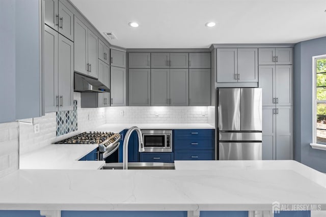 kitchen featuring appliances with stainless steel finishes, gray cabinets, visible vents, and under cabinet range hood