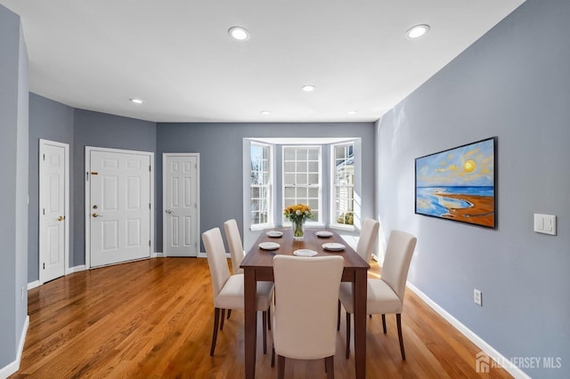 dining area with recessed lighting, wood finished floors, and baseboards