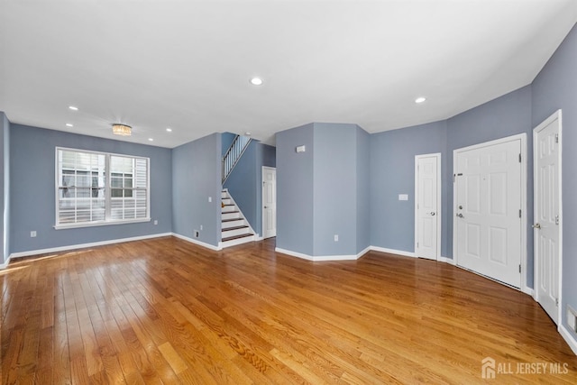 entrance foyer with light wood-style floors, recessed lighting, baseboards, and stairs