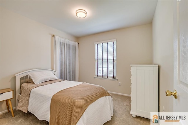 bedroom with carpet floors and baseboards