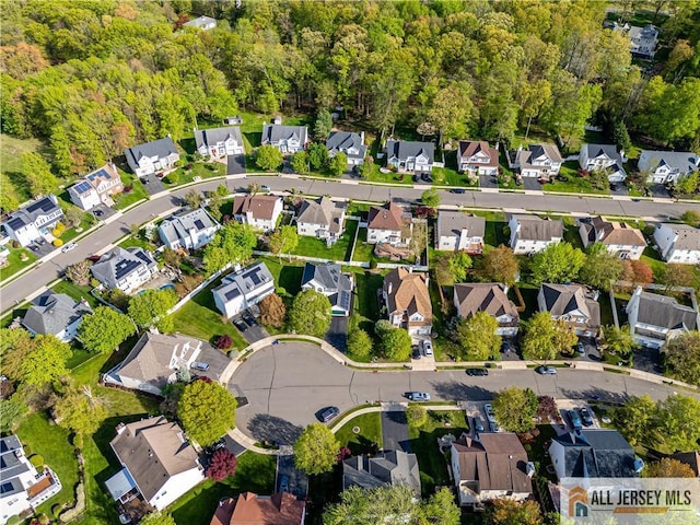 bird's eye view with a residential view and a wooded view