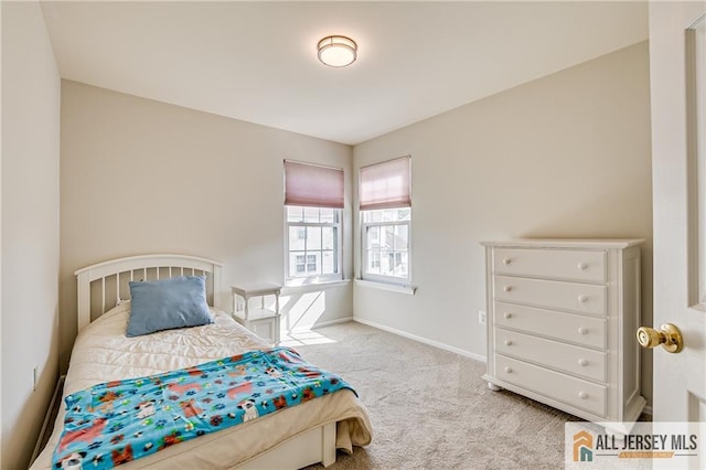 bedroom with baseboards and carpet