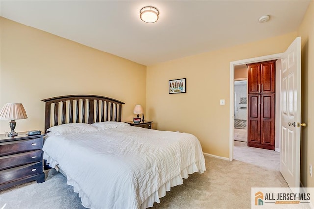 bedroom featuring light colored carpet and baseboards