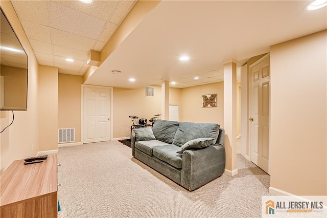 carpeted living room with baseboards and visible vents