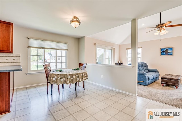 dining room featuring baseboards, a ceiling fan, lofted ceiling, and a healthy amount of sunlight