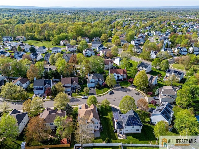 drone / aerial view featuring a forest view and a residential view