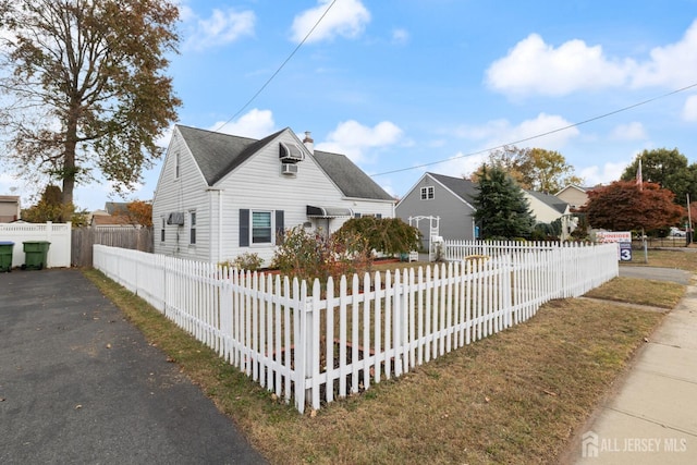 view of front of property featuring a fenced front yard and a chimney