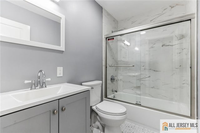 bathroom featuring vanity, toilet, and enclosed tub / shower combo