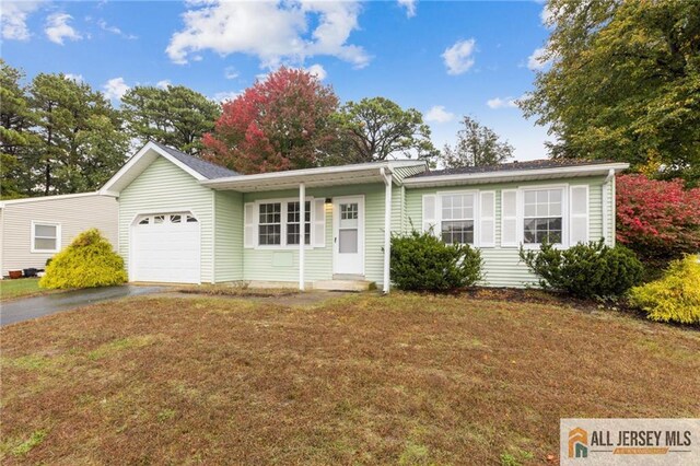 ranch-style house with a garage and a front lawn