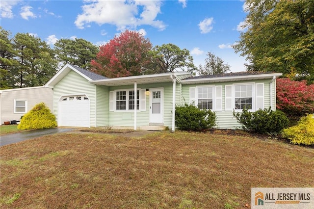 ranch-style house featuring a front lawn, an attached garage, and driveway