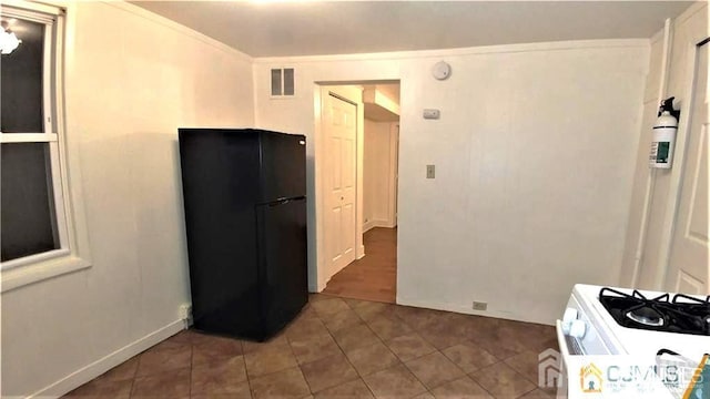19 Haag St, Sayreville, NJ 08872 - kitchen with freestanding refrigerator, tile patterned floors, and white gas range