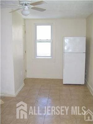 19 Haag St, Sayreville, NJ 08872 - tiled empty room featuring a ceiling fan and baseboards