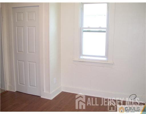 19 Haag St, Sayreville, NJ 08872 - empty room with baseboards and dark wood-type flooring