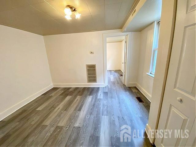 19 Haag St, Sayreville, NJ 08872 - spare room with dark wood finished floors and baseboards
