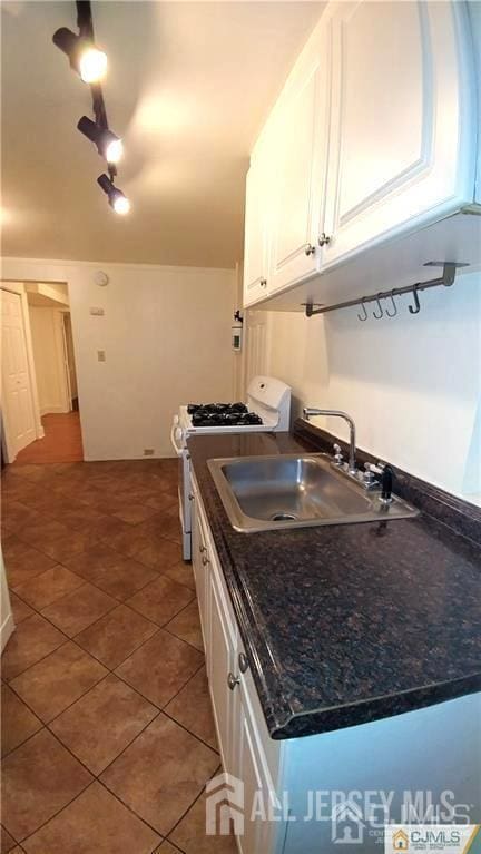 19 Haag St, Sayreville, NJ 08872 - kitchen featuring gas range gas stove, white cabinetry, tile patterned floors, and rail lighting