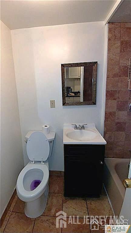 19 Haag St, Sayreville, NJ 08872 - full bathroom featuring vanity, tile patterned flooring, and washtub / shower combination