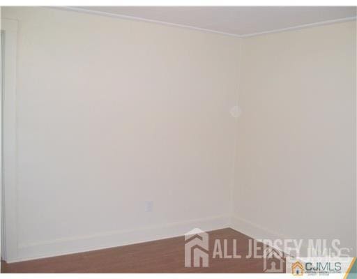19 Haag St, Sayreville, NJ 08872 - spare room featuring wood finished floors and crown molding