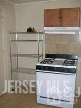 19 Haag St, Sayreville, NJ 08872 - kitchen with gas range gas stove, under cabinet range hood, and brown cabinetry
