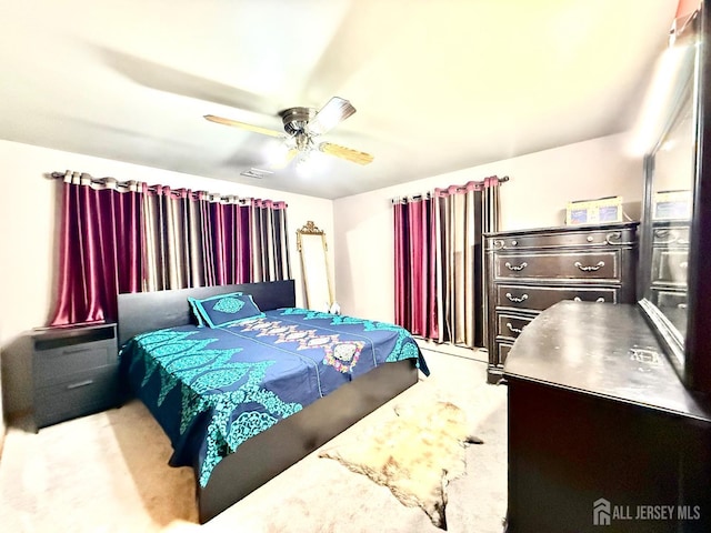 bedroom featuring ceiling fan, visible vents, and carpet