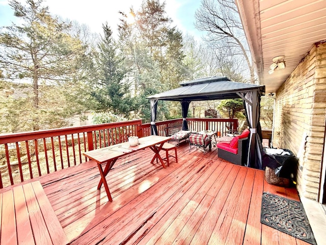 wooden deck featuring a gazebo and an outdoor hangout area