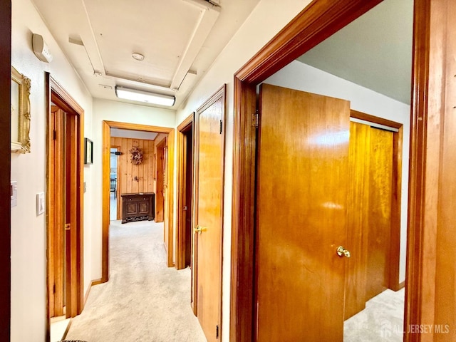 hall featuring light colored carpet