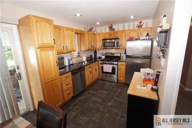 313 Demorest Ave, Avenel, NJ 07001 - kitchen with appliances with stainless steel finishes, backsplash, recessed lighting, and dark countertops
