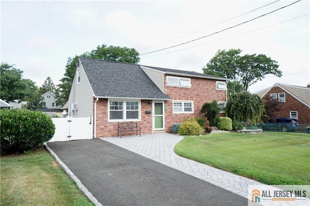 313 Demorest Ave, Avenel, NJ 07001 - view of front facade with a gate, brick siding, roof with shingles, and a garage