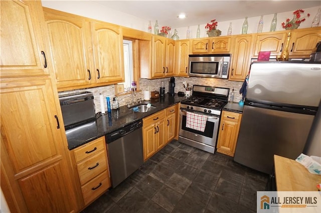 313 Demorest Ave, Avenel, NJ 07001 - kitchen featuring appliances with stainless steel finishes, decorative backsplash, and dark stone countertops