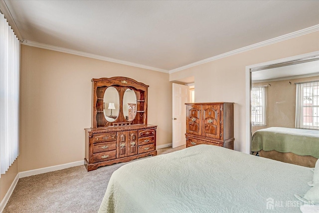 carpeted bedroom featuring crown molding and baseboards
