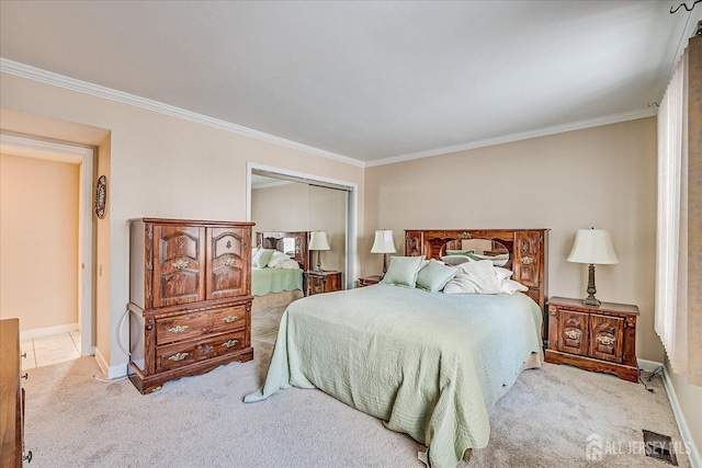 carpeted bedroom with baseboards, ornamental molding, and a closet