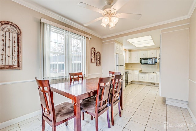 dining area with a ceiling fan, baseboards, ornamental molding, and light tile patterned flooring