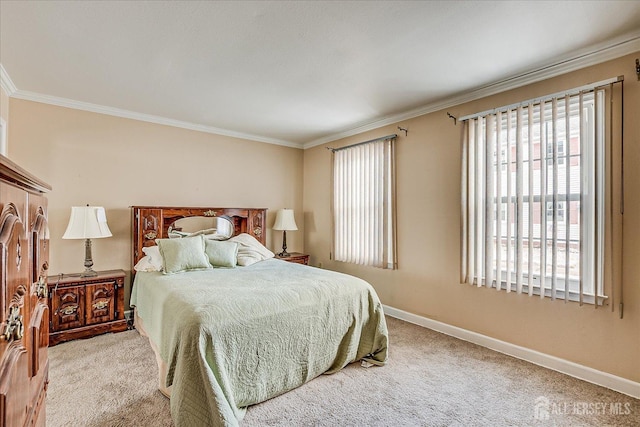 carpeted bedroom with crown molding and baseboards