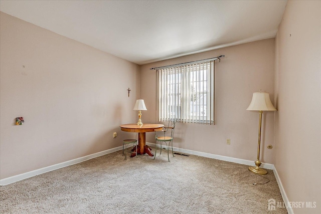 living area featuring baseboards, carpet flooring, and visible vents