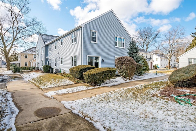 view of side of property featuring a residential view and central AC unit