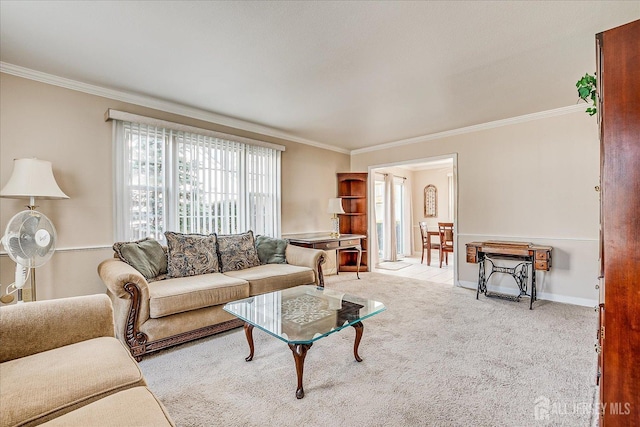carpeted living area featuring crown molding and baseboards