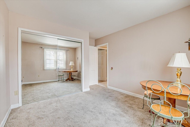 sitting room with baseboards and carpet flooring