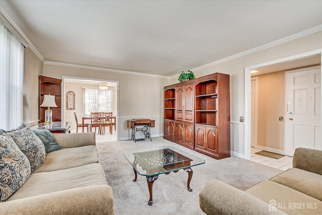 living room featuring baseboards, ornamental molding, and light colored carpet