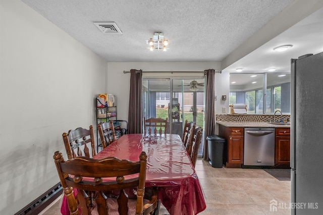 209-A Vernon Rd, Monroe, NJ 08831 - dining room with plenty of natural light, a baseboard radiator, a textured ceiling, and light tile patterned floors