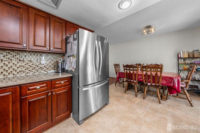 209-A Vernon Rd, Monroe, NJ 08831 - kitchen featuring freestanding refrigerator, decorative backsplash, and light stone countertops