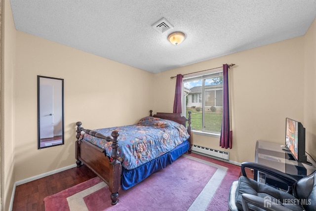 209-A Vernon Rd, Monroe, NJ 08831 - bedroom with a baseboard heating unit, baseboards, a textured ceiling, and wood finished floors
