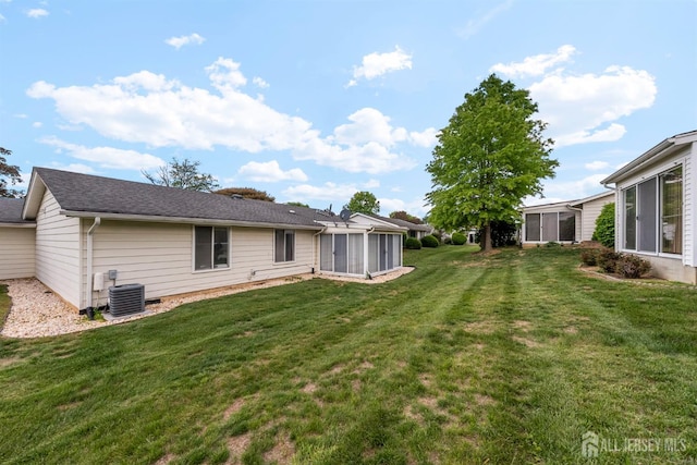 209-A Vernon Rd, Monroe, NJ 08831 - rear view of house with a sunroom, a yard, and central air condition unit