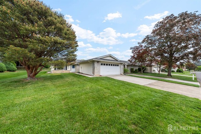209-A Vernon Rd, Monroe, NJ 08831 - ranch-style home with concrete driveway, a garage, a front yard, and brick siding