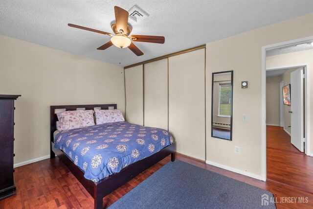 209-A Vernon Rd, Monroe, NJ 08831 - bedroom with wood finished floors, a closet, a ceiling fan, baseboards, and a textured ceiling