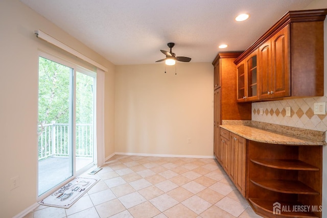 85 W Shrewsbury Pl, Princeton, NJ 08540 - kitchen featuring backsplash, open shelves, a ceiling fan, brown cabinets, and light stone countertops