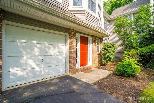 85 W Shrewsbury Pl, Princeton, NJ 08540 - entrance to property with brick siding, an attached garage, and driveway