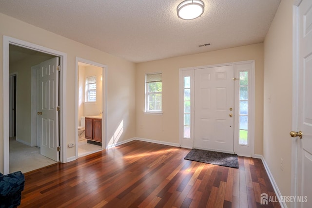 85 W Shrewsbury Pl, Princeton, NJ 08540 - foyer entrance with wood-type flooring, a textured ceiling, and baseboards